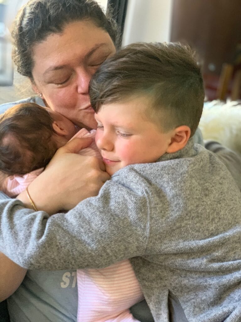 Alexandra Fisher hugging her children